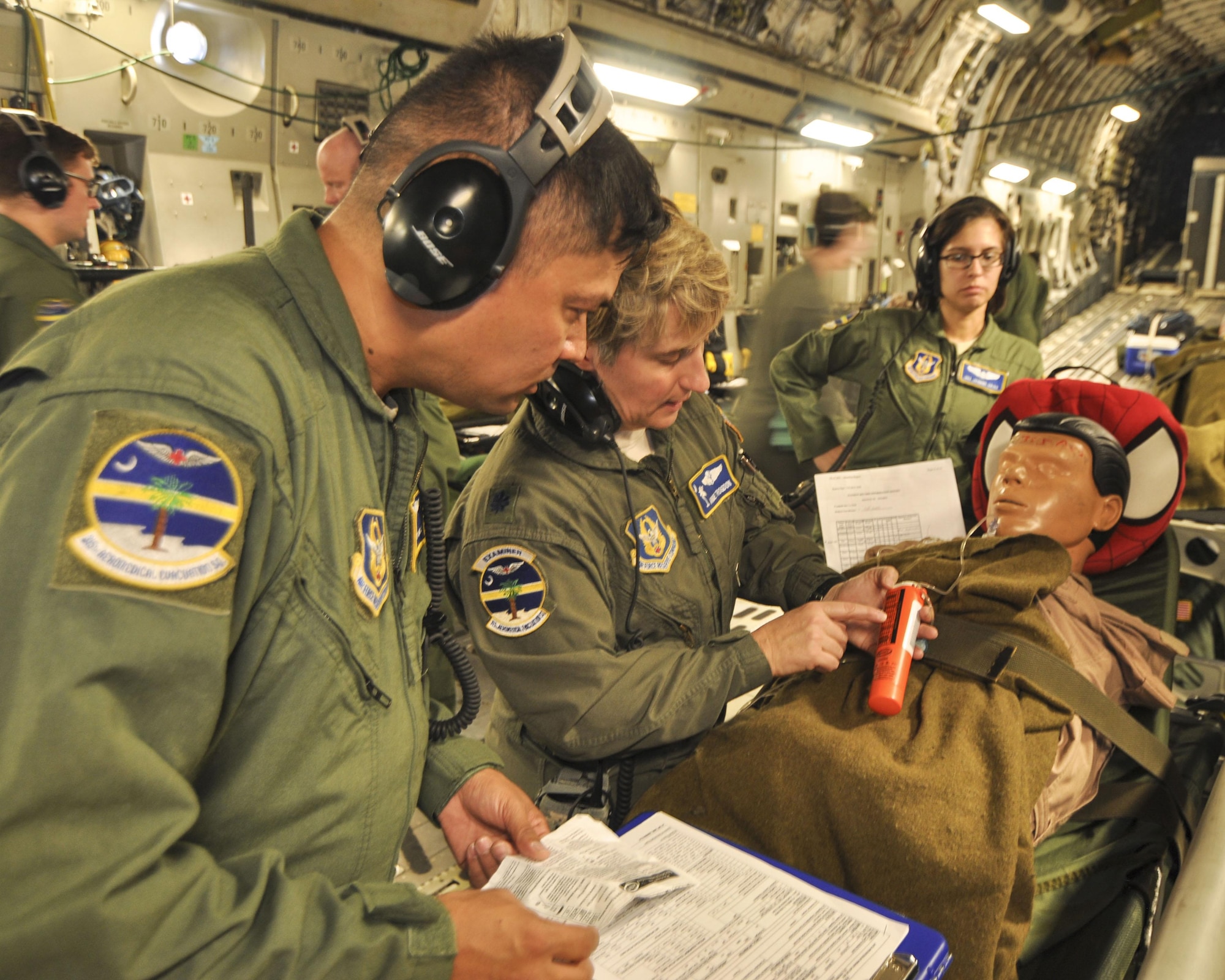 Lt. Col. Angie Trogdon, a flight nurse with 315th Aeromedical Evacuation Squadron at Joint Base Charleston goes over medical procedures with Master Sgt. Robert Jonas on a recent off-station training mission. (U.S. Air Force Photo by Maj. Wayne Capps)
