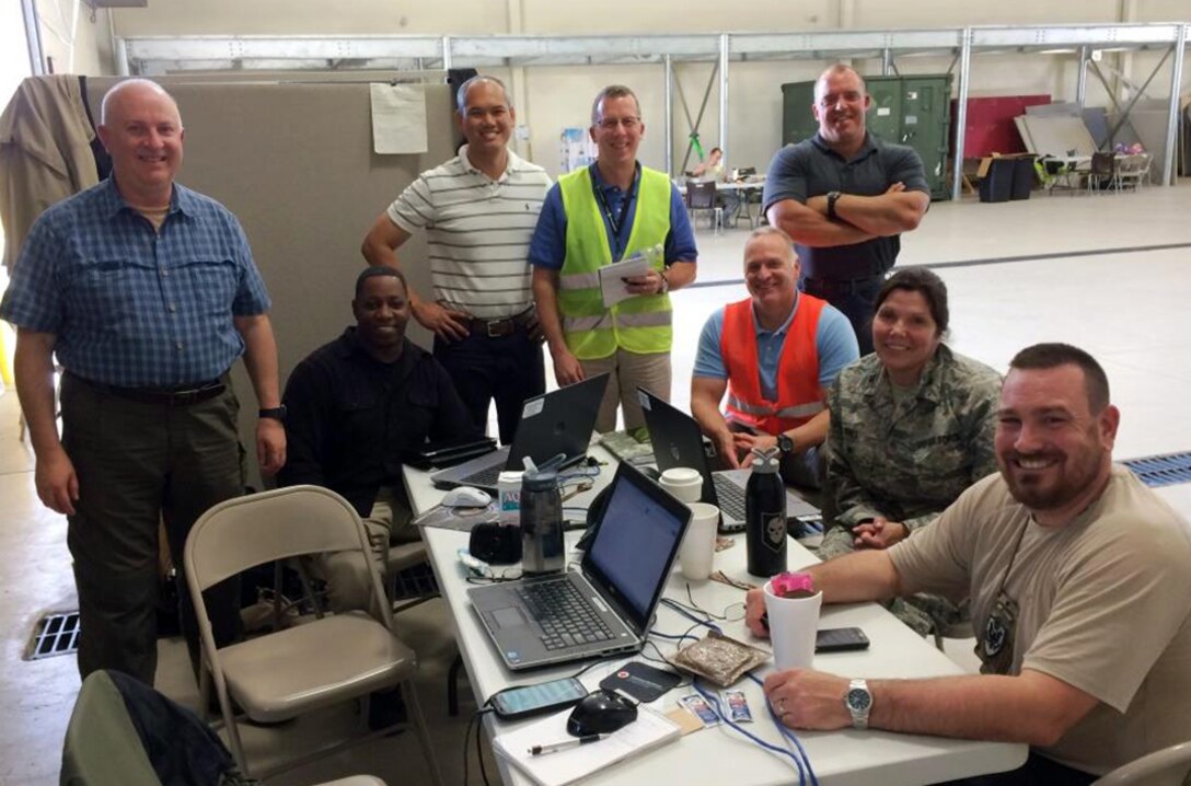 (From left) Defense Logistics Agency employees Craig Hill, Andre Hinson, Paul Chanman, John Snead, Jeff Crosson, Eugene Summers, Air Force Col. Michelle Hall and Hank Morrow conduct an after-action review for the “Turbo Distribution” exercise in Gulfport, Mississippi, Oct. 23-30.