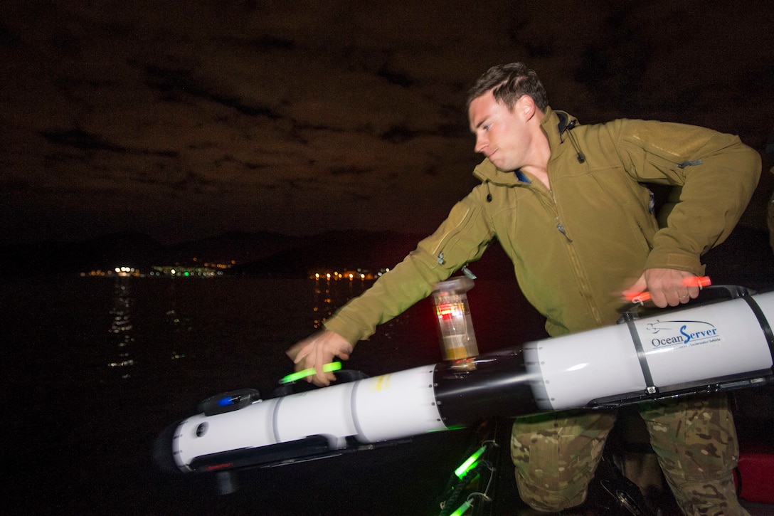 U.S. Navy Petty Officer 3rd Class Kaden Ross launches the IVER unmanned underwater vehicle during Clear Horizon 2015 on Commander Fleet Activities Chinhae, South Korea, Nov. 10, 2015. Ross is an explosive ordnance disposal technician assigned to Explosive Ordnance Disposal Mobile Unit 5. U.S. Navy photo by Petty Officer 2nd Class Daniel Rolston