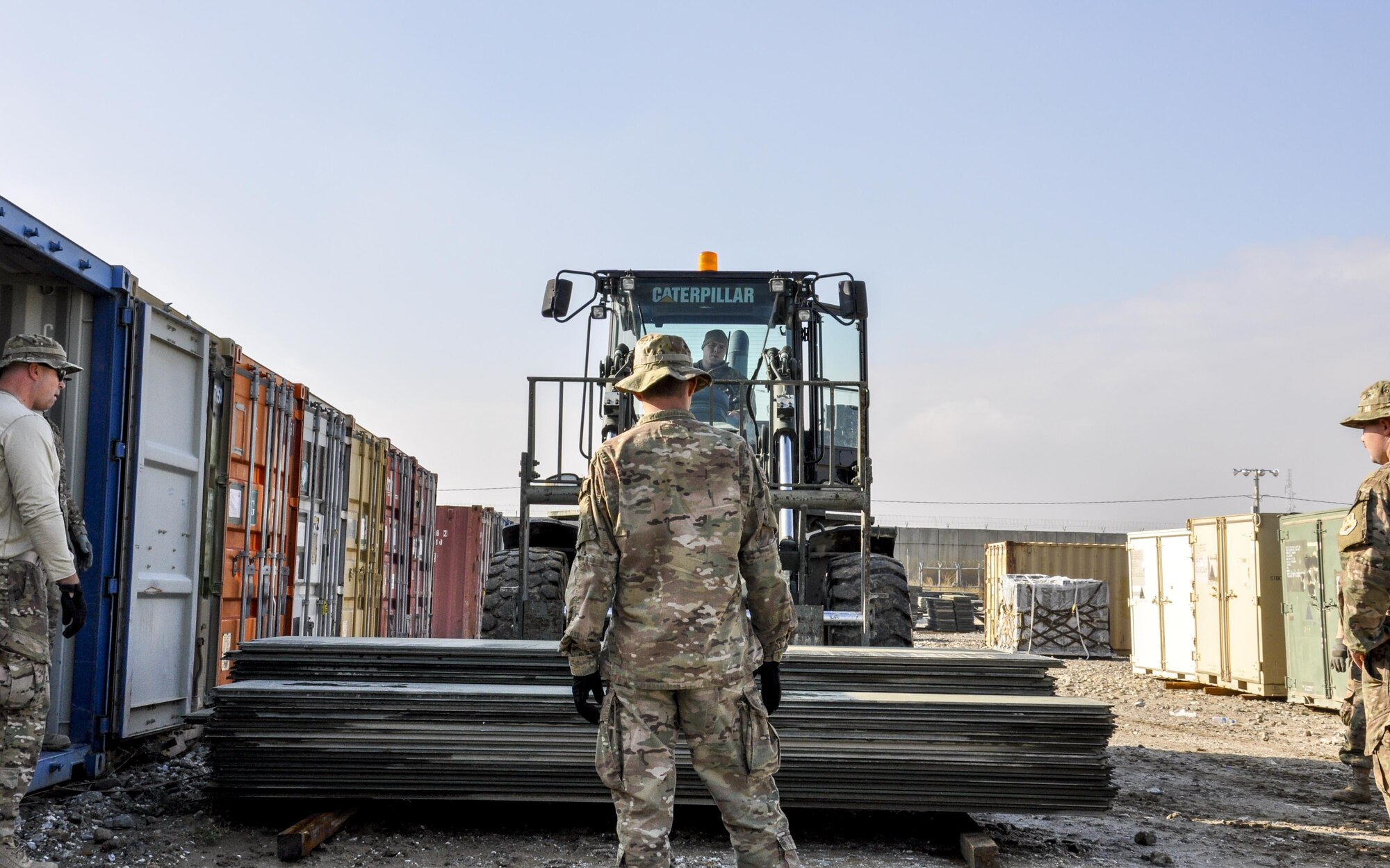 Senior Airman Jack Bragg, right, 455th Expeditionary Logistics Squadron vehicle operator, deployed from Barksdale Air Force Base, La., and Staff Sgt. Christopher Sumner, Central Command Materiel Recovery Element team member, deployed from Little Rock AFB, Ark., prepare to consolidate aircraft ground paneling into storage for redeployment at Bagram Airfield, Afghanistan, Nov. 13, 2015. The CMRE team is designed to account for and redeploy war reserve assets after they have fulfilled their intended purpose, so they are available for use elsewhere. The team worked numerous hours over six days to manually move 480,852 pounds of material, consolidate 29 shipping containers, and inventory nearly 81,000 square feet of the matting worth $1.5 million. (U.S. Air Force photo by Tech. Sgt. Nicholas Rau/Released)