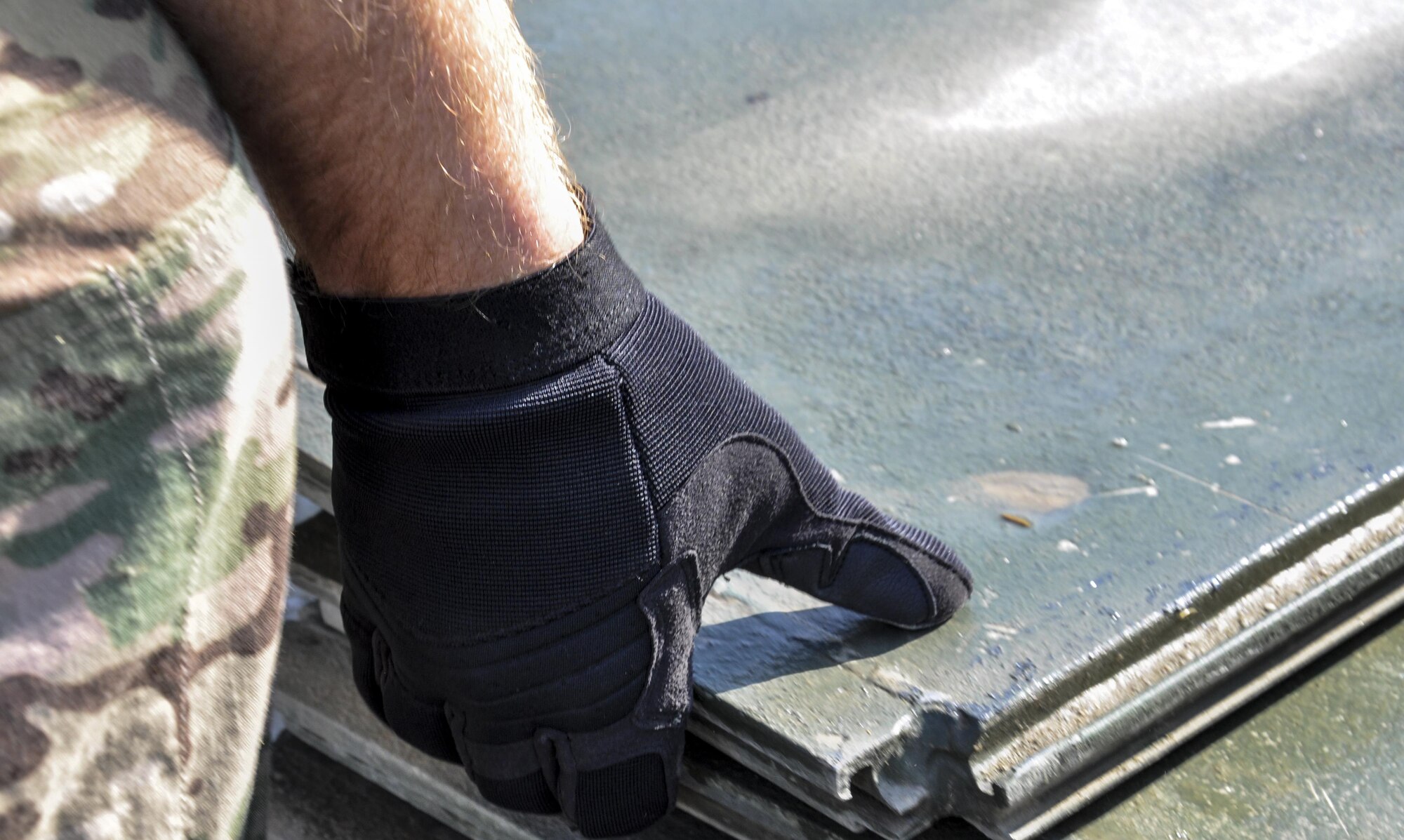 An Airman with the Central Command Materiel Recovery Element team lifts aircraft ground paneling into storage for redeployment at Bagram Airfield, Afghanistan, Nov. 13, 2015. The CMRE team is designed to account for and redeploy war reserve assets after they have fulfilled their intended purpose, so they are available for use elsewhere. The team worked numerous hours over six days to manually move 480,852 pounds of material, consolidate 29 shipping containers, and inventory nearly 81,000 square feet of the matting worth $1.5 million. (U.S. Air Force photo by Tech. Sgt. Nicholas Rau/Released)