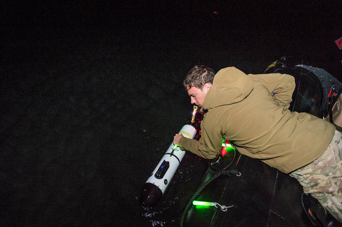 U.S. Navy Petty Officer 3rd Class Kaden Ross conducts a visual inspection on the IVER unmanned underwater vehicle during Clear Horizon 2015 on Commander Fleet Activities Chinhae, South Korea, Nov. 10, 2015. Ross is an explosive ordnance disposal technician assigned to Explosive Ordnance Disposal Mobile Unit 5. U.S. Navy photo by Petty Officer 2nd Class Daniel Rolston