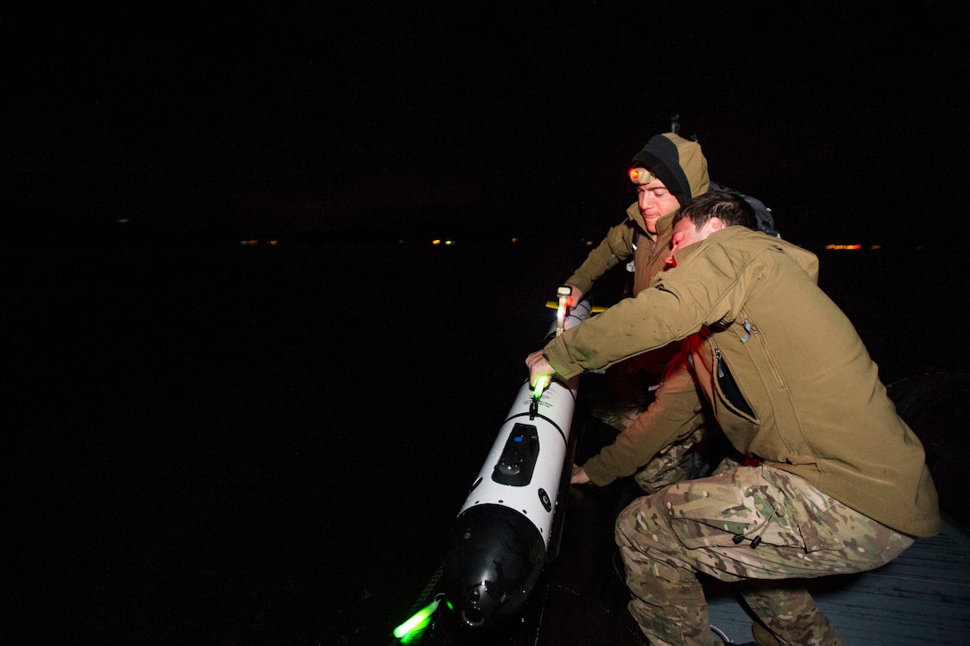 U.S. Navy Petty Officer 3rd Class Kaden Ross, right, and U.S. Navy Lt. J.G. Scott Kendrick recover the IVER unmanned underwater vehicle after its mission was completed during Clear Horizon 2015 on Commander Fleet Activities Chinhae, South Korea, Nov. 10, 2015. Ross and Kendrick are assigned to Explosive Ordnance Disposal Mobile Unit 5. U.S. Navy photo by Petty Officer 2nd Class Daniel Rolston