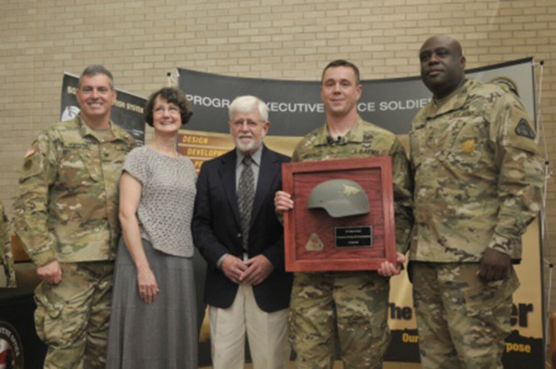 Army 1st Lt. Jeffrey Meek holds the advanced combat helmet that saved his life from an enemy round in 2012 in Afghanistan, during a Nov. 13, 2015, ceremony at Fort Hood, Texas. The Program Executive Office Soldier agency returned the helmet to Meek to demonstrate the Army's support and confidence in its equipment. U.S. Army photo by Sgt. Brandon Banzhaf