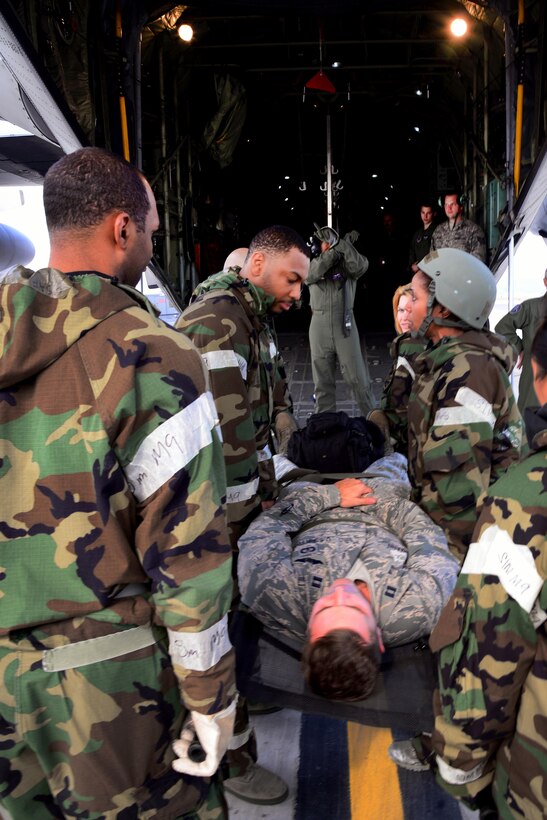 U.S. airmen participating in Vigilant Ace 16 prepare to load a simulated casualty into an HC-130 Combat King II cargo aircraft on Osan Air Base, South Korea, Nov. 5, 2015. The airmen are assigned to the 51st Medical Group. U.S. Air Force photo by Staff Sgt. Benjamin Sutton