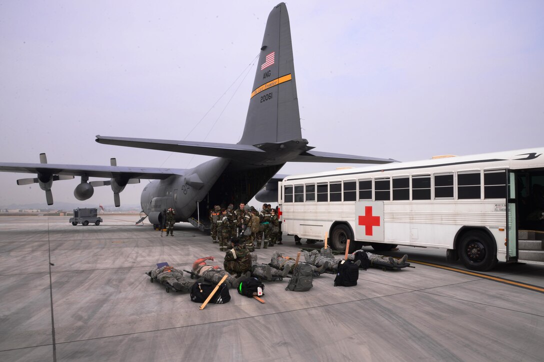 U.S. airmen load simulated casualties into an HC-130 Combat King II cargo aircraft during Vigilant Ace 16 on Osan Air Base, South Korea, Nov. 5, 2015. U.S. Air Force photo by Staff Sgt. Benjamin Sutton