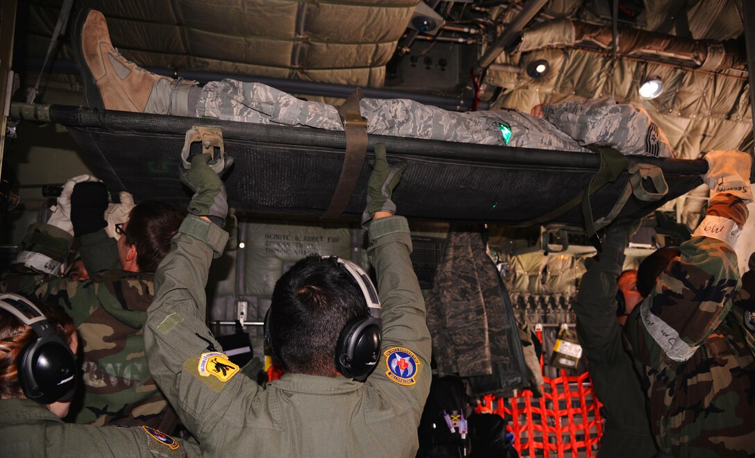 U.S. airmen secure a simulated casualty during a Vigilant Ace 16 aeromedical evacuation exercise on Osan Air Base, South Korea, Nov. 5, 2015. U.S. Air Force photo by Staff Sgt. Benjamin Sutton