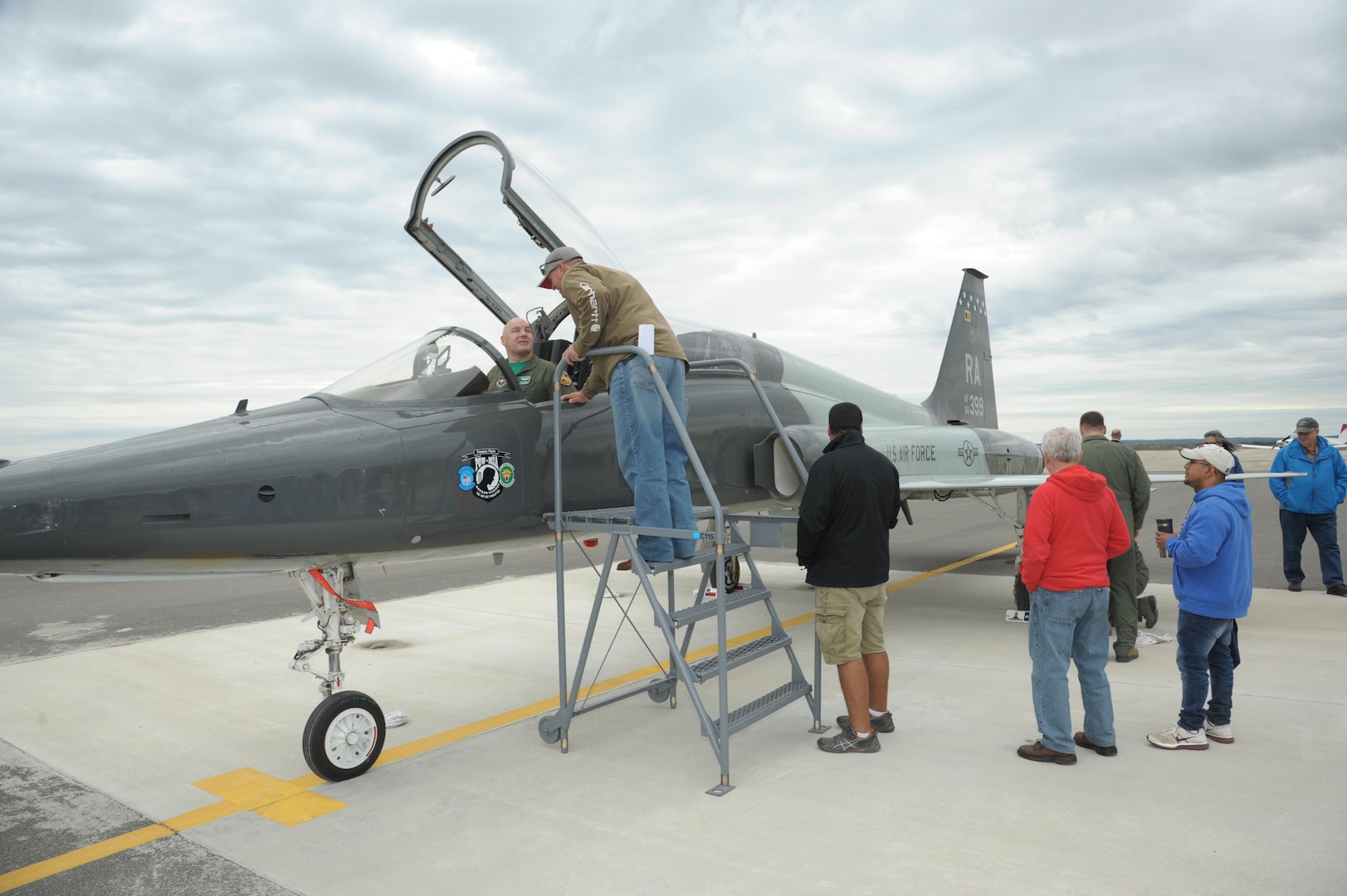 Maj. Vince Sherer, 560th Flying Training Squadron, student instructor, shows the T-38 Talon aircraft to spectators, during the Joint Base San Antonio Seguin Auxiliary Airfield Open House, Nov. 13, 2015. JBSA-Randolph Auxiliary Airfield is used solely by the 560th Flying Training Squadron for preparing instructors for undergraduate pilot training T-38 training assignments.  The 560th primarily uses Seguin Auxfield for practice landings in a pilot controlled pattern called instead of FAA controllers. (U.S. Air Force photo by Joel Martinez/Released) 