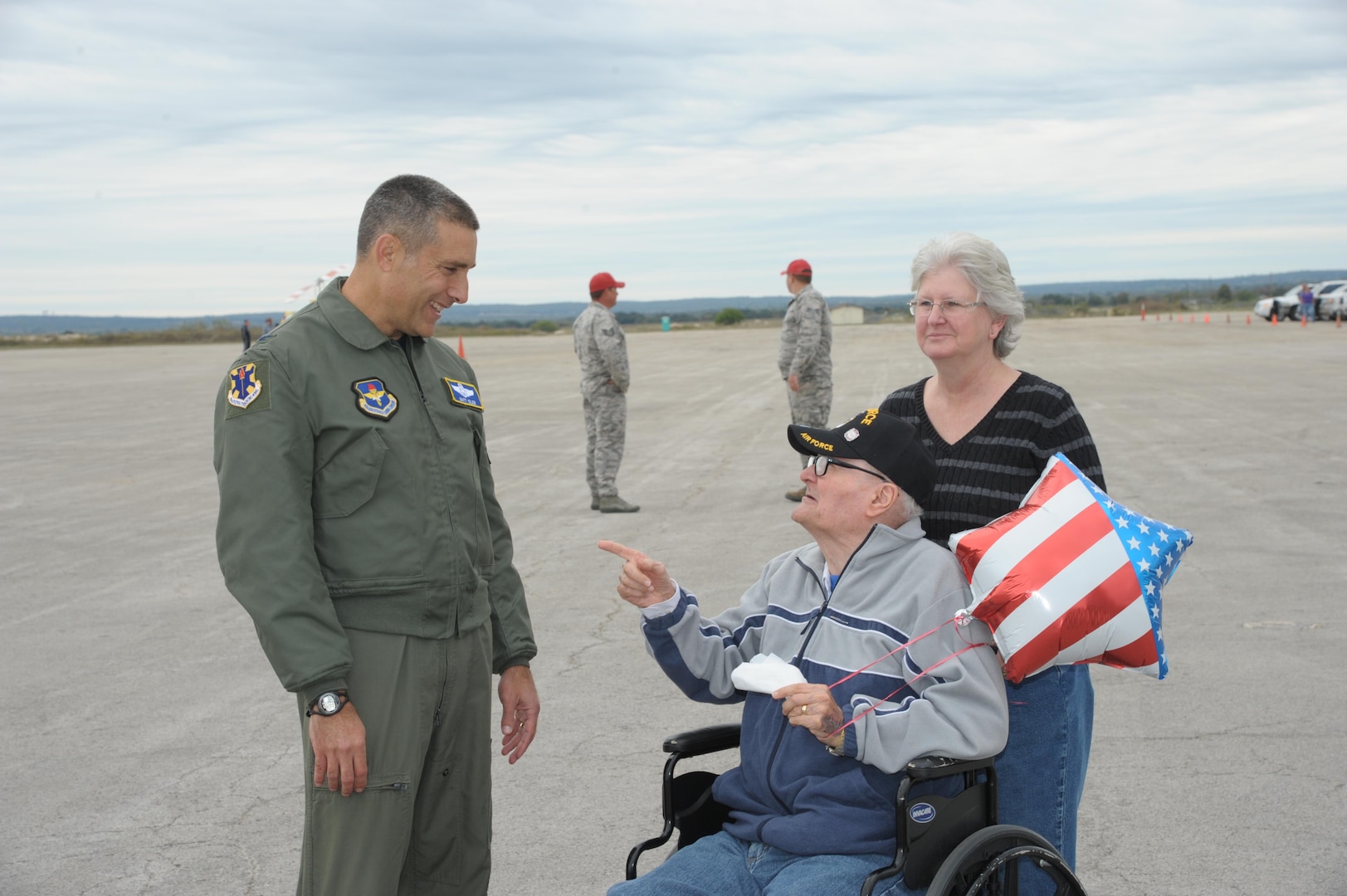 Col. Matthew Isler, 12th Flying Training Wing, commander, greets Chaplain Lt. Col. Ret. Kenyon Hutchenson and Cindy Rogers, during the Joint Base San Antonio Seguin Auxiliary Airfield Open House, Nov. 13, 2015. JBSA-Randolph Auxiliary Airfield is used solely by the 560th Flying Training Squadron for preparing instructors for undergraduate pilot training T-38 training assignments.  The 560th primarily uses Seguin Auxfield for practice landings in a pilot controlled pattern called instead of FAA controllers. (U.S. Air Force photo by Joel Martinez/Released) 