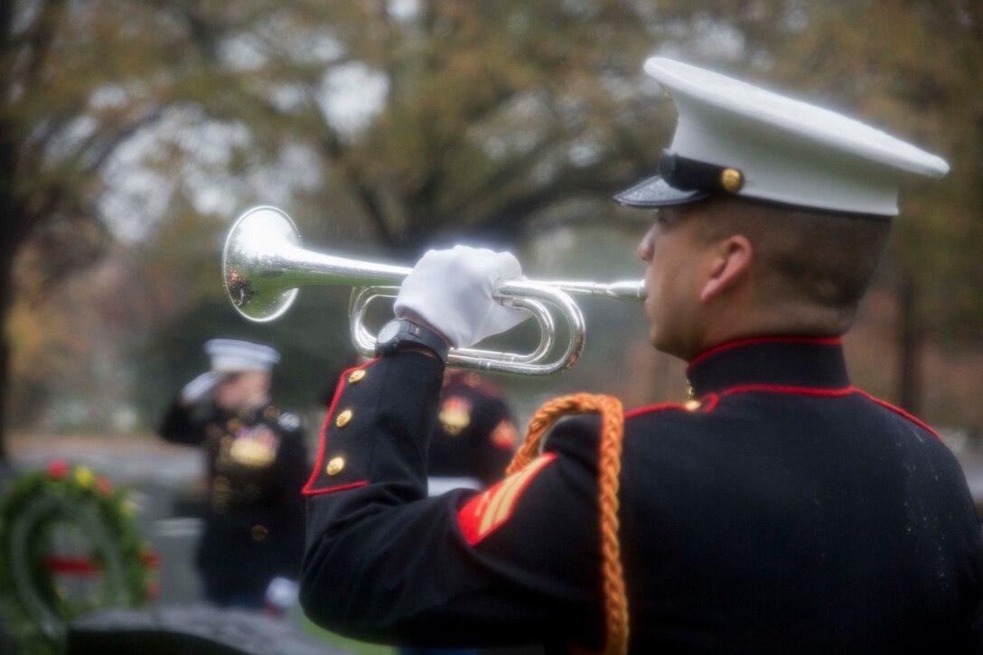 Corporal Ramiro De Leon performs "Taps" on the Marine Corps birthday at Arlington National Cemetery. (US Marine Corps Photo by Cpl. Skye Davis/Released)