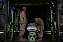 Captain Brian Jaquith, company commander of Co. A, 3rd Assault Amphibian Battalion, 1st Marine Division, cuts the ceremonial cake to present to the oldest and youngest Marine present, Master Sgt. George Roan and Pfc. Pedro Montano, in celebration of the Marine Corps’ 240th birthday aboard Yuma Proving Grounds, Ariz., Nov. 10, 2015. The Marines and Sailors celebrated the birthday as a culminating event to the 18-day field operation.