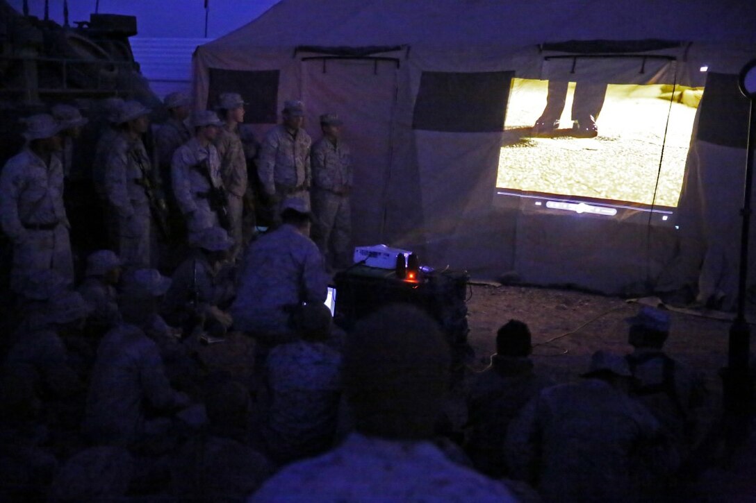 Marines and Sailors assigned to Company A, 3rd Assault Amphibian Battalion, 1st Marine Division, watch the commandant’s birthday message in celebration of the Marine Corps’ 240th birthday aboard Yuma Proving Grounds, Ariz., Nov. 10, 2015. The Marines and Sailors celebrated the birthday as a culminating event to the 18-day field operation.