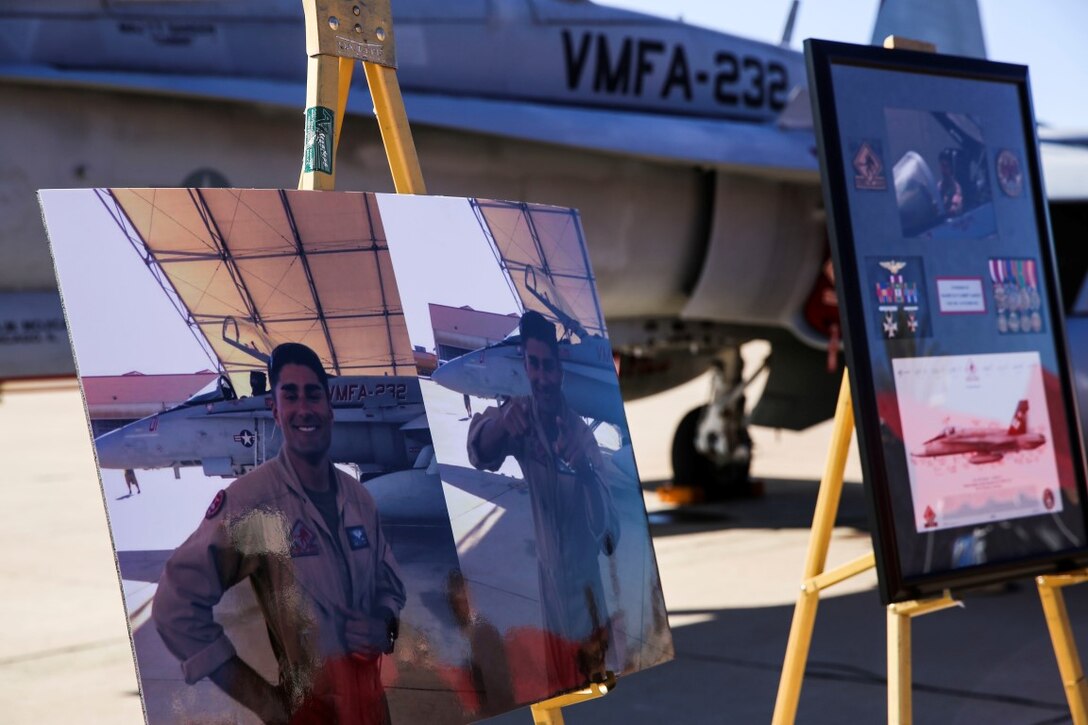 Photos of Maj. Taj Sareen, a pilot with Marine Fighter Attack Squadron 232, are displayed in front of an F/A-18C Hornet during a memorial ceremony aboard Marine Corps Air Station Miramar, Calif., Nov. 13. Sareen died on Oct. 21 when his jet crashed during his return flight following a six-month deployment in support of Operation Inherent Resolve.