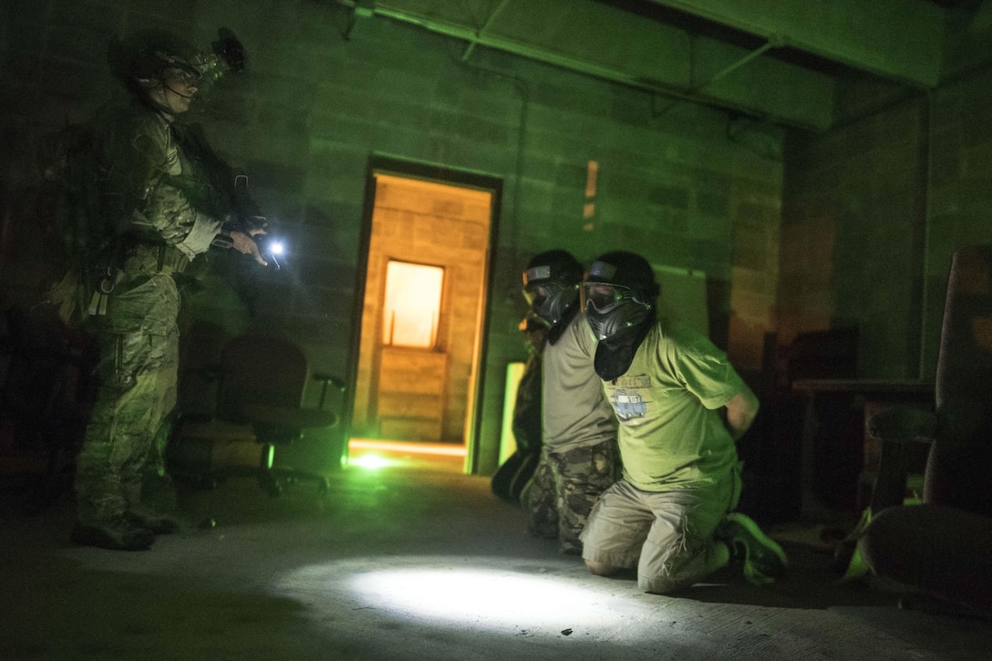 A special operations airman treats and processes rescued hostages during a noncombatant evacuation exercise as part of Southern Strike 16 on Meridian Naval Air Station, Miss., Nov. 3, 2015. New York National Guard photo by Air Force Staff Sgt. Christopher S. Muncy    