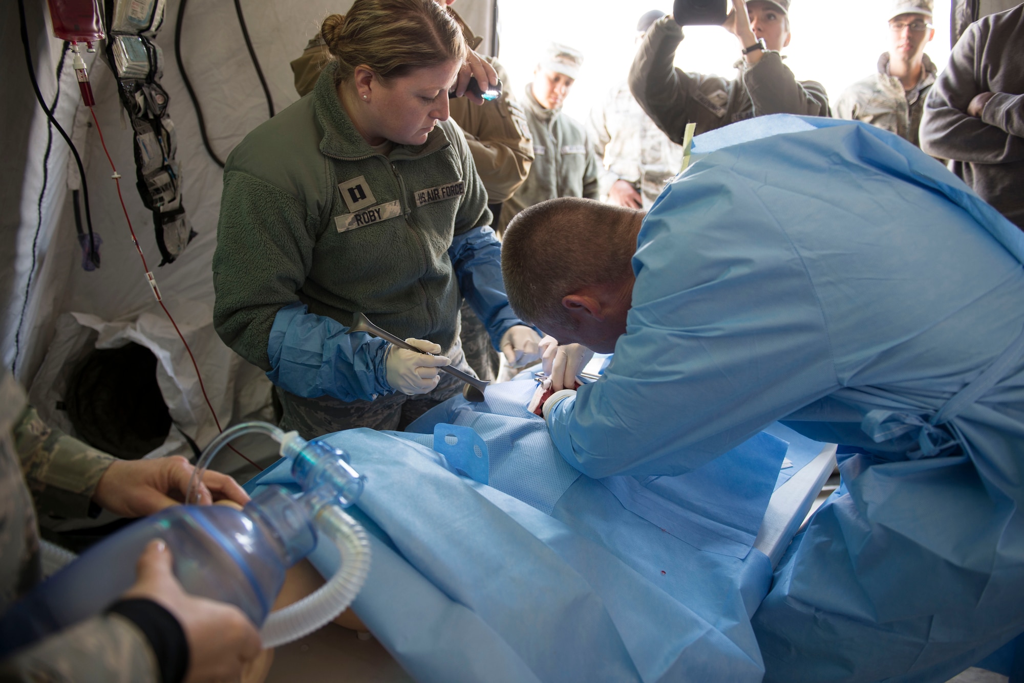 A surgical team rushes into action on a simulated fatal injury during Gunfighter Flag 16-1 at Mountain Home Air Force Base, Idaho, Nov. 5, 2015. Some simulated injuries were meant to be distractions from others to test the team’s ability to triage different injuries. (U.S. Air Force photo/Airman 1st Class Jessica H. Evans)