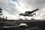 WATERS SOUTH OF JAPAN (Nov. 16, 2015) Capt. Chris Bolt, commanding officer of the U.S. Navy's only forward-deployed aircraft carrier USS Ronald Reagan (CVN 76), pilots an E-2C Hawkeye from the "Liberty Bells" of Carrier Airborne Early Warning Squadron (VAW) 115 as it prepares to land on the ship's flight deck. Ronald Reagan and its embarked air wing, Carrier Air Wing (CVW) 5, provide a combat-ready force that protects and defends the collective maritime interests of the U.S. and its allies and partners in the Indo-Asia-Pacific region.