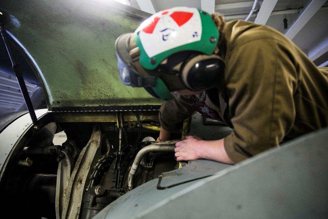 INDIAN OCEAN (Nov. 6, 2015) U.S. Marine Sgt. Taylor Harris does maintenance on an MV-22B Osprey in the hangar bay of the USS Essex (LHD 2). Harris is a non-destructive inspection technician with Medium Marine Tiltrotor Squadron 161 (Reinforced), 15th Marine Expeditionary Unit. Marines with the MEU’s aviation combat element work together to ensure the aircraft are in good condition and safe to fly. The 15th MEU is currently deployed in the Indo-Asia-Pacific region to promote regional stability and security in the U.S. 7th Fleet area of operations. (U.S. Marine Corps photo by Sgt. Anna Albrecht/Released)