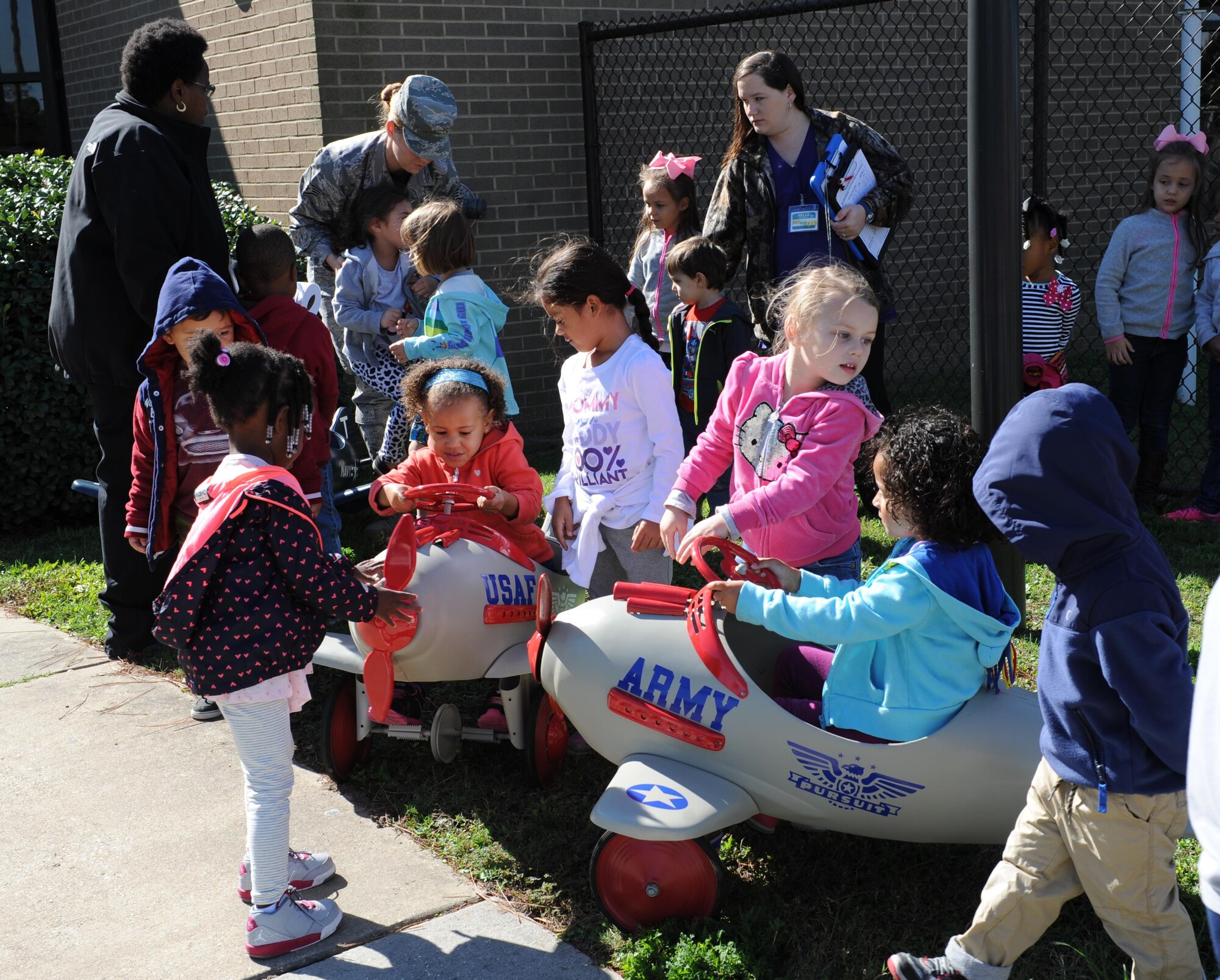 Children at the child development center play with the newly refurbished pedal airplanes Nov. 13, 2015, Keesler Air Force Base, Miss. The four pedal airplanes, refurbished by the Trainer Development Center, have been in storage for more than 10 years. The project was spearheaded by the Keesler parent advisory board. (U.S. Air Force photo by Kemberly Groue)