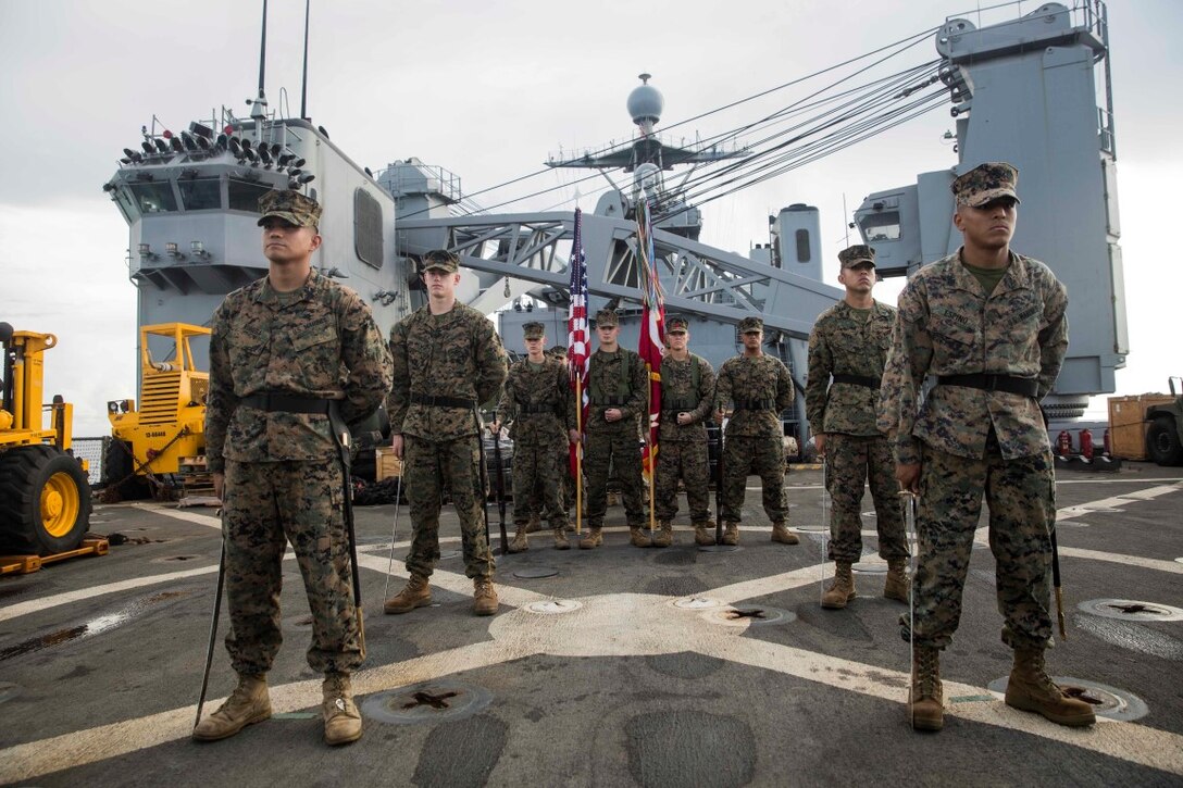 SOUTH CHINA SEA (Nov. 9, 2015) U.S. Marines with the 15th Marine Expeditionary Unit stand ready to begin a ceremony celebrating the Marine Corps’ 240th birthday aboard USS Rushmore (LSD 47). The ceremony included a reading of Gen. John A. Lejeune’s birthday message and a cake-cutting to celebrate 240 years of tradition, service, and victory. The 15th MEU is currently deployed in the Indo-Asia-Pacific region to promote regional stability and security in the U.S. 7th Fleet area of operations. (U.S. Marine Corps photo by Sgt. Emmanuel Ramos/Released)
