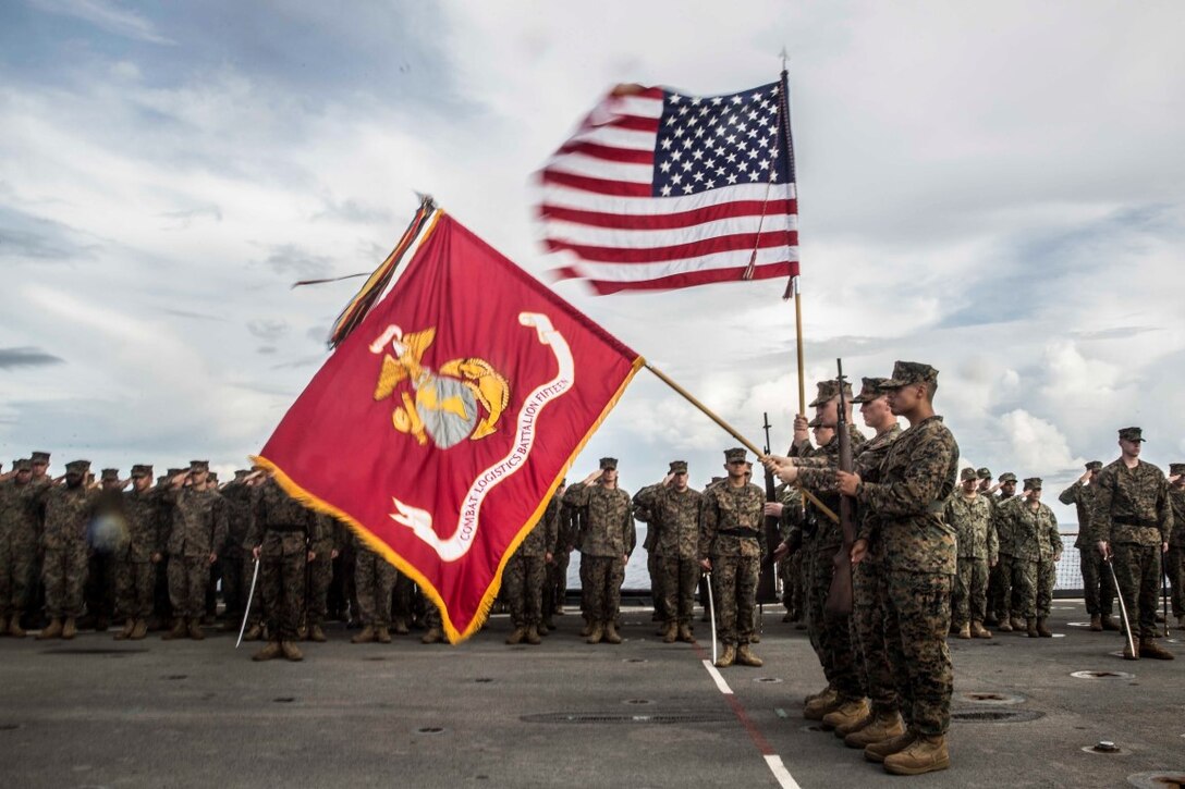 SOUTH CHINA SEA (Nov. 9, 2015) U.S. Marines with the 15th Marine Expeditionary Unit present the organizational colors during the Marine Corps birthday ceremony aboard USS Rushmore (LSD 47). The ceremony included a reading of Gen. John A. Lejeune’s birthday message and a cake-cutting to celebrate 240 years of tradition, service, and victory. The 15th MEU is currently deployed in the Indo-Asia-Pacific region to promote regional stability and security in the U.S. 7th Fleet area of operations. (U.S. Marine Corps photo by Sgt. Emmanuel Ramos/Released)