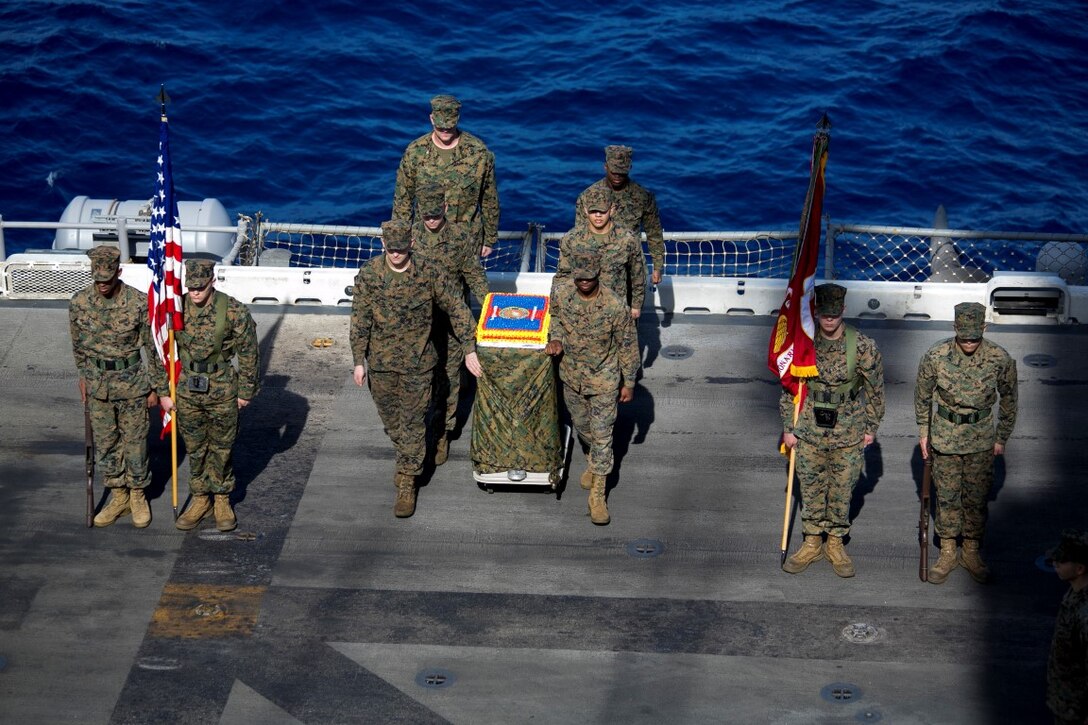 SOUTH CHINA SEA (Nov. 10, 2015) U.S. Marines with the 15th Marine Expeditionary Unit guide a cake during a ceremony to celebrate the Marines Corps’ 240th birthday aboard the USS Essex (LHD 2).   The ceremony included a reading of Gen. John A. Lejeune’s birthday message and a cake-cutting to celebrate 240 years of tradition, service, and victory. The 15th MEU is currently deployed in the Indo-Asia-Pacific region to promote regional stability and security in the U.S. 7th Fleet area of operations. (U.S. Marine Corps photo by Sgt. Anna Albrecht/Released)