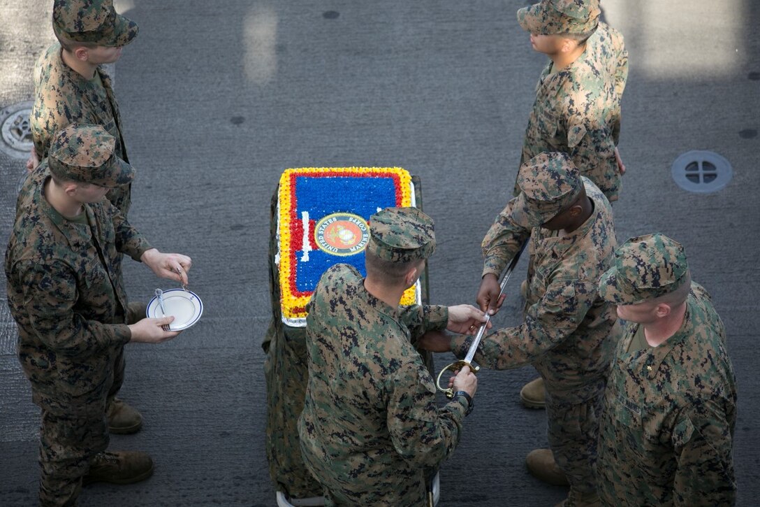 SOUTH CHINA SEA (Nov. 10, 2015) U.S. Marines with the 15th Marine Expeditionary Unit prepare to cut a cake during ceremony to celebrate the Marines Corps’ 240th birthday aboard the USS Essex (LHD 2). The ceremony included a reading of Gen. John A. Lejeune’s birthday message and a cake-cutting to celebrate 240 years of tradition, service, and victory. The 15th MEU is currently deployed in the Indo-Asia-Pacific region to promote regional stability and security in the U.S. 7th Fleet area of operations. (U.S. Marine Corps photo by Sgt. Anna Albrecht/Released)