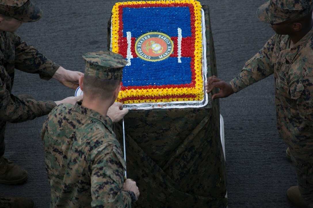SOUTH CHINA SEA (Nov. 10, 2015) U.S. Marine Col. Vance L. Cryer cuts a cake during a ceremony to celebrate the Marines Corps’ 240th birthday aboard the USS Essex (LHD 2). Cryer is the 15th Marine Expeditionary Unit’s commanding officer. In celebration of the Marine Corps’ birthday, the oldest Marine takes a bite of the cake and passes it to the youngest Marine, simulating the knowledge and tradition passing from the older generation to the younger. The ceremony included a reading of Gen. John A. Lejeune’s birthday message and a cake-cutting to celebrate 240 years of tradition, service, and victory.  The 15th MEU is currently deployed in the Indo-Asia-Pacific region to promote regional stability and security in the U.S. 7th Fleet area of operations. (U.S. Marine Corps photo by Sgt. Anna Albrecht/Released)