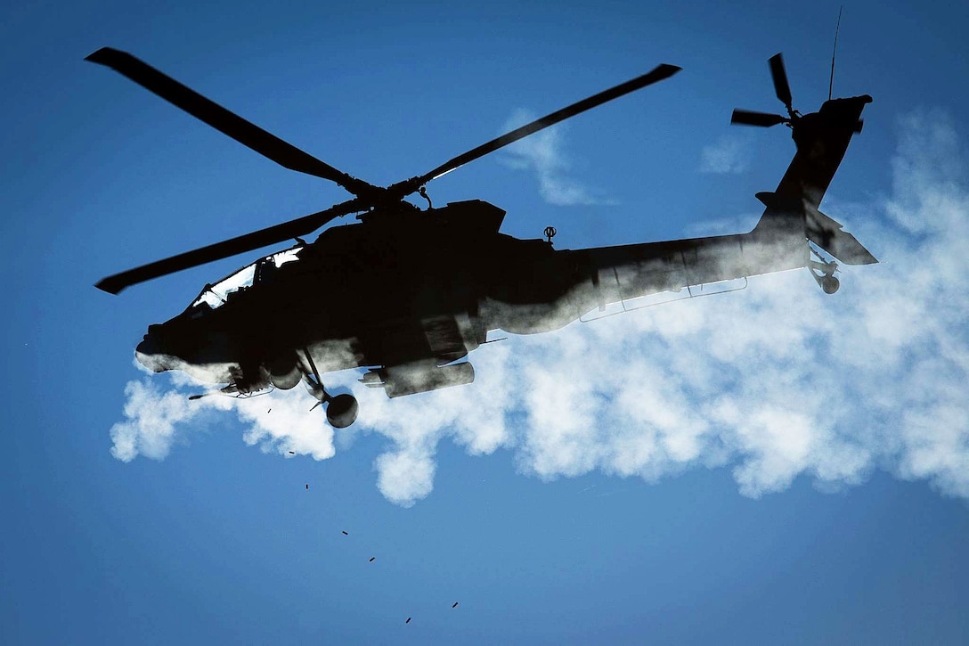 Army Lt. Col. Scott Nicholas and Chief Warrant Officer 3 Fred Heer fly a Texas Army National Guard AH-64D Apache helicopter while firing a 30 mm cannon during an aerial gunnery exercise on Fort Hood, Texas, Nov. 9th, 2015. U.S. Army photo by Major Randy Stillinger