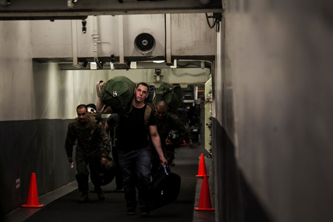 SOUTH CHINA SEA (Nov. 13, 2015) U.S. Marines with the 15th Marine Expeditionary Unit stage their gear before loading an aircraft aboard the USS Essex (LHD 2). The 15th MEU is currently deployed in the Indo-Asia-Pacific region to promote regional stability and security in the U.S. 7th Fleet area of operations. (U.S. Marine Corps photo by Cpl. Elize McKelvey/Released)