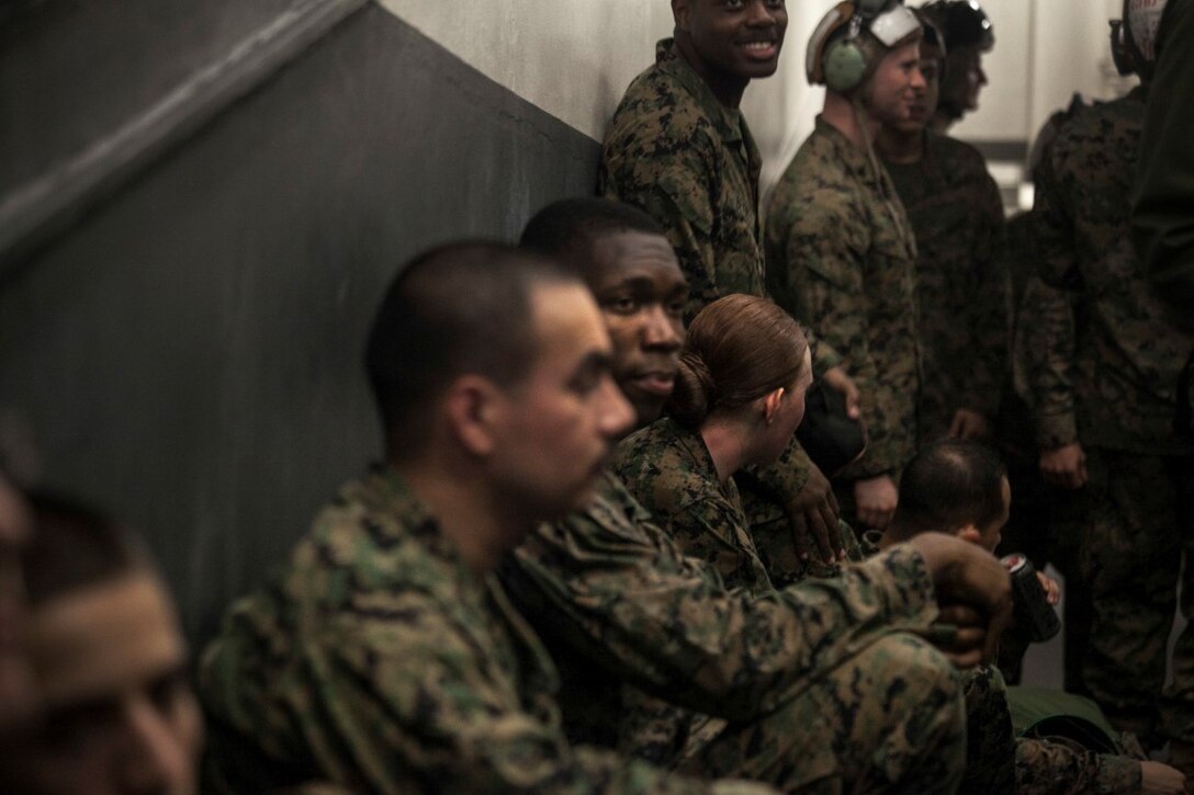SOUTH CHINA SEA (Nov. 13, 2015) U.S. Marines with the 15th Marine Expeditionary Unit wait to load in an aircraft aboard the USS Essex (LHD 2). The 15th MEU is currently deployed in the Indo-Asia-Pacific region to promote regional stability and security in the U.S. 7th Fleet area of operations. (U.S. Marine Corps photo by Cpl. Elize McKelvey/Released)