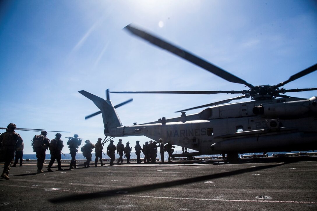SOUTH CHINA SEA (Nov. 14, 2015) U.S. Marines with Lima Company, Battalion Landing Team 3rd Battalion, 1st Marine Regiment, 15th Marine Expeditionary Unit, load onto a  CH-53E Super Stallion during a quick reaction force rehearsal aboard the USS Essex (LHD 2). The 15th MEU is currently deployed in the Indo-Asia-Pacific region to promote regional stability and security in the U.S. 7th Fleet area of operations. (U.S. Marine Corps photo by Cpl. Elize McKelvey/Released)