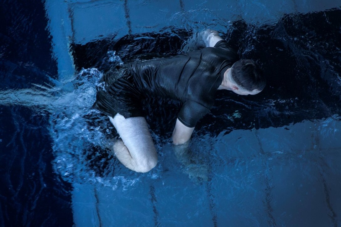 SOUTH CHINA SEA (Nov. 15, 2015) A U.S. Marine with the 15th Marine Expeditionary Unit  bear-crawls his way back on ship during a swim call aboard the USS Essex (LHD 2). The Marines and Sailors of the 15th MEU and Essex Amphibious Ready Group jumped 30-feet into the water and swam to their respective check point. The 15th MEU is currently deployed in the Indo-Asia-Pacific region to promote regional stability and security in the U.S. 7th Fleet area of operations. (U.S. Marine Corps photo by Cpl. Elize McKelvey/Released)