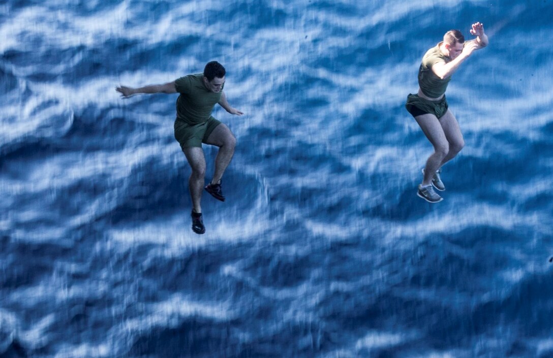 SOUTH CHINA SEA (Nov. 15, 2015) U.S. Marines with the 15th Marine Expeditionary Unit jump off the side of the USS Essex (LHD 2) during a swim call. The Marines and Sailors of the 15th MEU and Essex Amphibious Ready Group jumped 30-feet into the water and swam to their respective check point. The 15th MEU is currently deployed in the Indo-Asia-Pacific region to promote regional stability and security in the U.S. 7th Fleet area of operations. (U.S. Marine Corps photo by Cpl. Elize McKelvey/Released)