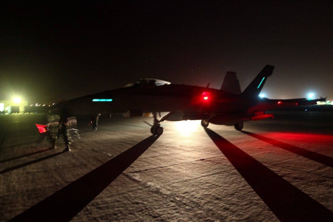 U.S. Marine aviation ordnance technicians with Marine Fighter Attack Squadron-232, Special Purpose Marine Air-Ground Task Force—Crisis Response—Central Command, prepare an F/A-18 Hornet to launch for a strike mission in Southwest Asia, June 9, 2015. Pilots of VMFA-232 support Combined Joint Task Force – Operation Inherent Resolve with a combination of surveillance flights and kinetic strike missions, enabling Iraqi Security Forces in their fight against the Islamic State of Iraq and the Levant. (U.S. Marine Corps Photo by Cpl. Leah Agler)