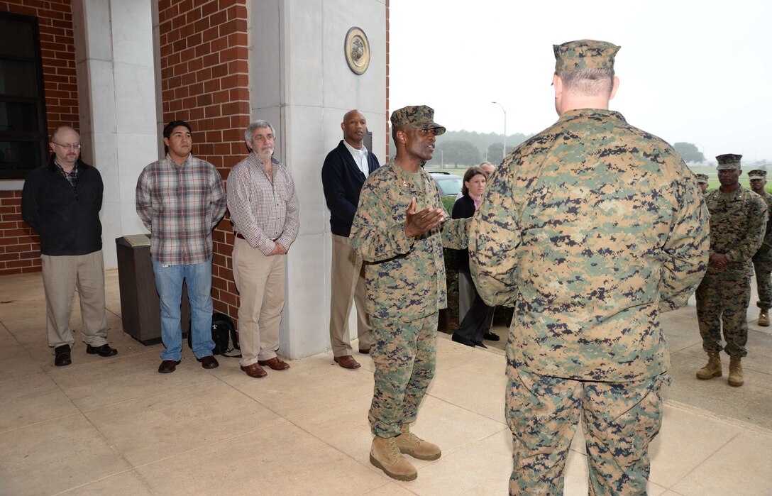 Standing at attention in front of a formation of fellow service members and civilian-Marines at Marine Corps Logistics Base Albany, Lt. Cmdr. Dennis J. Riordan, receives a commendation during a brief ceremony honoring his achievement. Col. James C. Carroll III, commanding officer, MCLB Albany, pinned the Meritorious Service Medal on Riordan, public works officer, Installation and Environmental Branch, MCLB Albany, while Lt. Col. Nathaniel Robinson, executive officer, MCLB Albany, read President Barack Obama’s citation. The event was held at Coffman Hall, Bldg. 3500, Nov. 9.