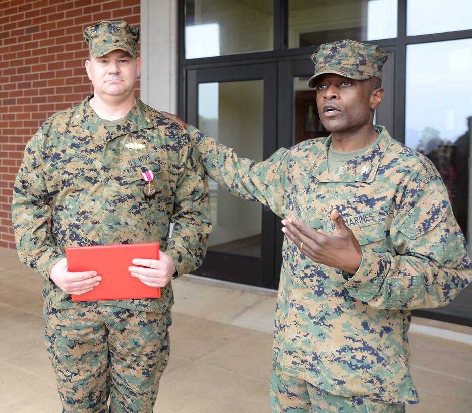 Standing at attention in front of a formation of fellow service members and civilian-Marines at Marine Corps Logistics Base Albany, Lt. Cmdr. Dennis J. Riordan, receives a commendation during a brief ceremony honoring his achievement. Col. James C. Carroll III, commanding officer, MCLB Albany, pinned the Meritorious Service Medal on Riordan, public works officer, Installation and Environmental Branch, MCLB Albany, while Lt. Col. Nathaniel Robinson, executive officer, MCLB Albany, read President Barack Obama’s citation. The event was held at Coffman Hall, Bldg. 3500, Nov. 9.