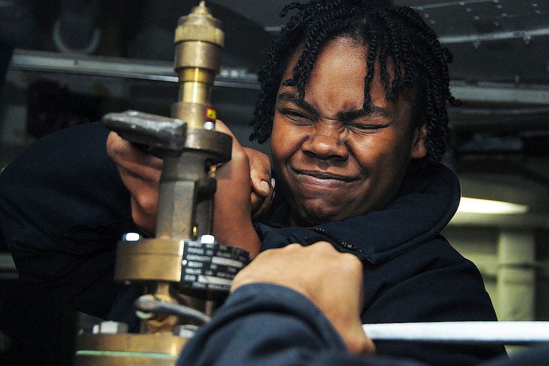 U.S. Navy Seaman Allyson Jones rebuilds a temperature-regulating valve aboard aircraft carrier USS George Washington in the Atlantic Ocean, Nov. 14, 2015. The Washington is deployed around South America as a part of Southern Seas 2015, an exercise to enhance interoperability, increase regional stability and build and maintain relationships with countries throughout the region. Jones is a machinist's mate fireman. U.S. Navy photo by Seaman Devin Bowser