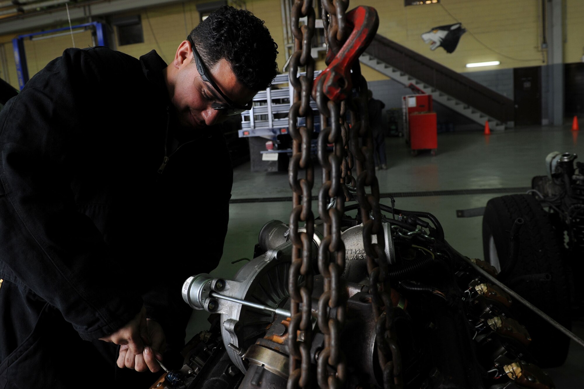 U.S. Air Force Senior Airman Anthony Benitez, 8th LRS vehicle maintainer prepares an engine after it is removed from a vehicle at Kunsan Air Base, Republic of Korea, Nov. 13, 2015. Though vehicle maintaining is the 8th LRS vehicle maintainer’s primary duty; everyone can help them by taking care of the vehicles that are used daily and essential to the mission. (U.S. Air Force photo by Senior Airman Ashley L. Gardner/Released)
