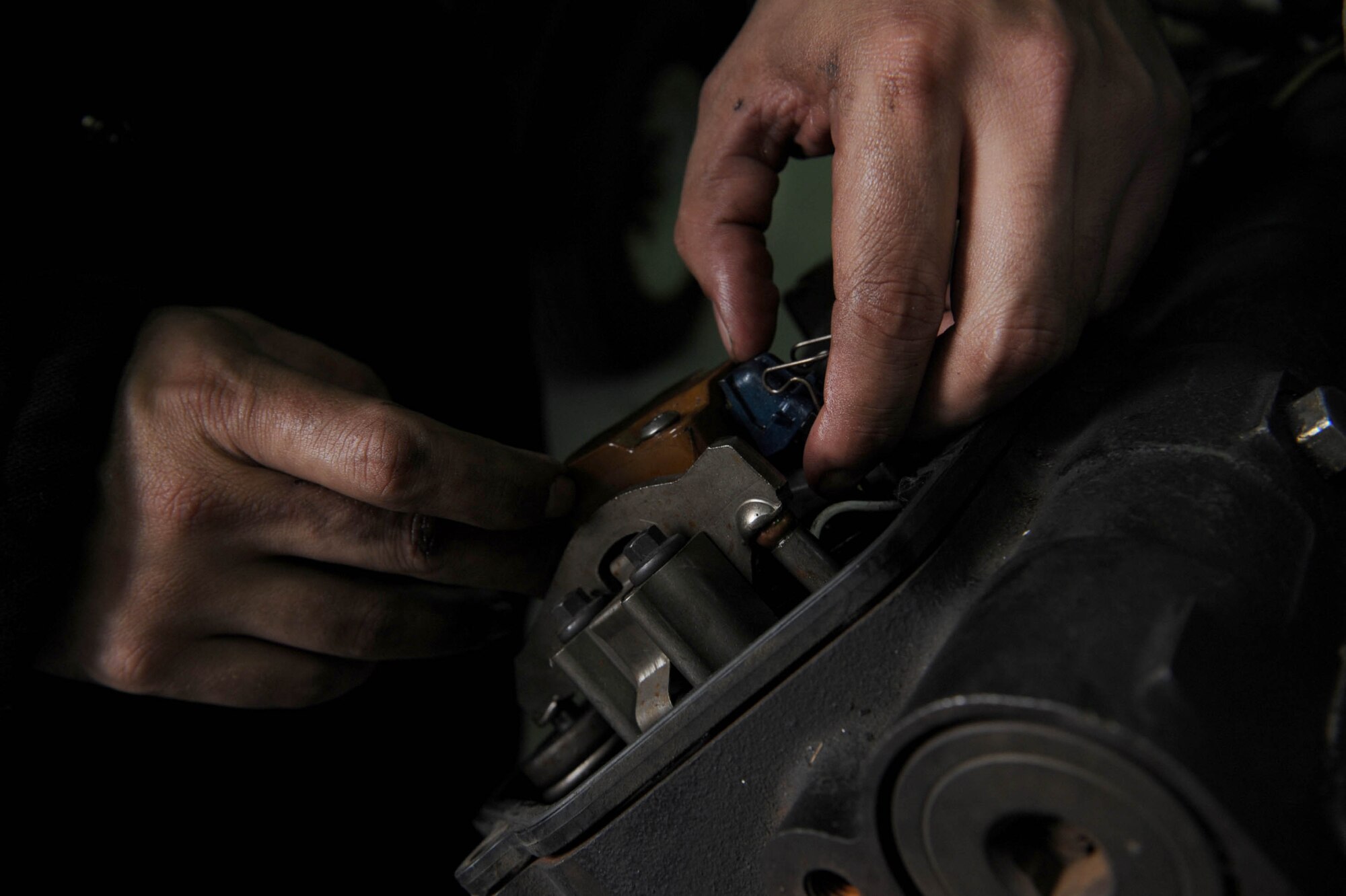 U.S. Air Force Senior Airman Anthony Benitez, 8th LRS vehicle maintainer prepares an engine after it is removed from a vehicle at Kunsan Air Base, Republic of Korea, Nov. 13, 2015. Vehicle maintainers must know how to work on all types of vehicles. 