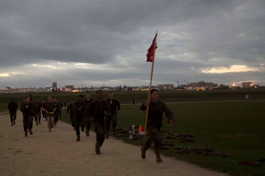 Marines run laps around the Semper Fit track Nov. 10 on Marine Corps Air Station Futenma, Okinawa, Japan. They ran 240 laps to celebrate the 240th Marine Corps Birthday. It took the Marines over seven hours to finish. After completing 60 miles, the Marines held a cake cutting ceremony to honor Marine Corps History.