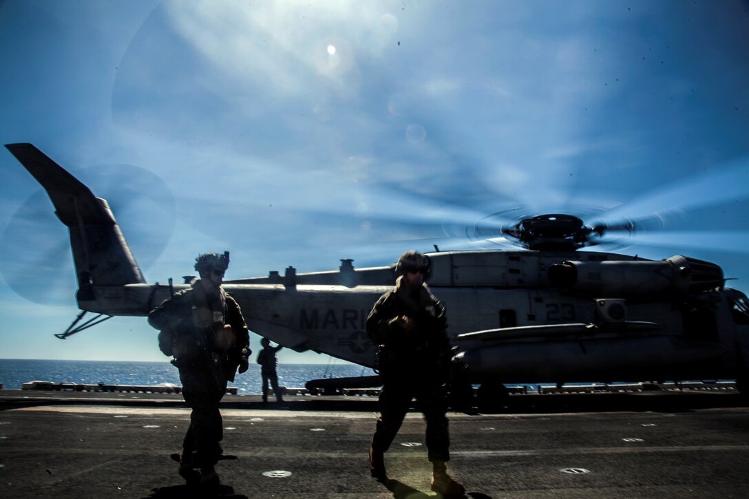 U.S. Marines with Lima Company, Battalion Landing Team 3rd Battalion, 1st Marine Regiment, 15th Marine Expeditionary Unit, offload from a CH-53E Super Stallion, Nov. 14, 2015 during a quick reaction force rehearsal aboard the USS Essexon the South China Sea. The 15th MEU is currently deployed in the Indo-Asia-Pacific region to promote regional stability and security in the U.S. 7th Fleet area of operations. 