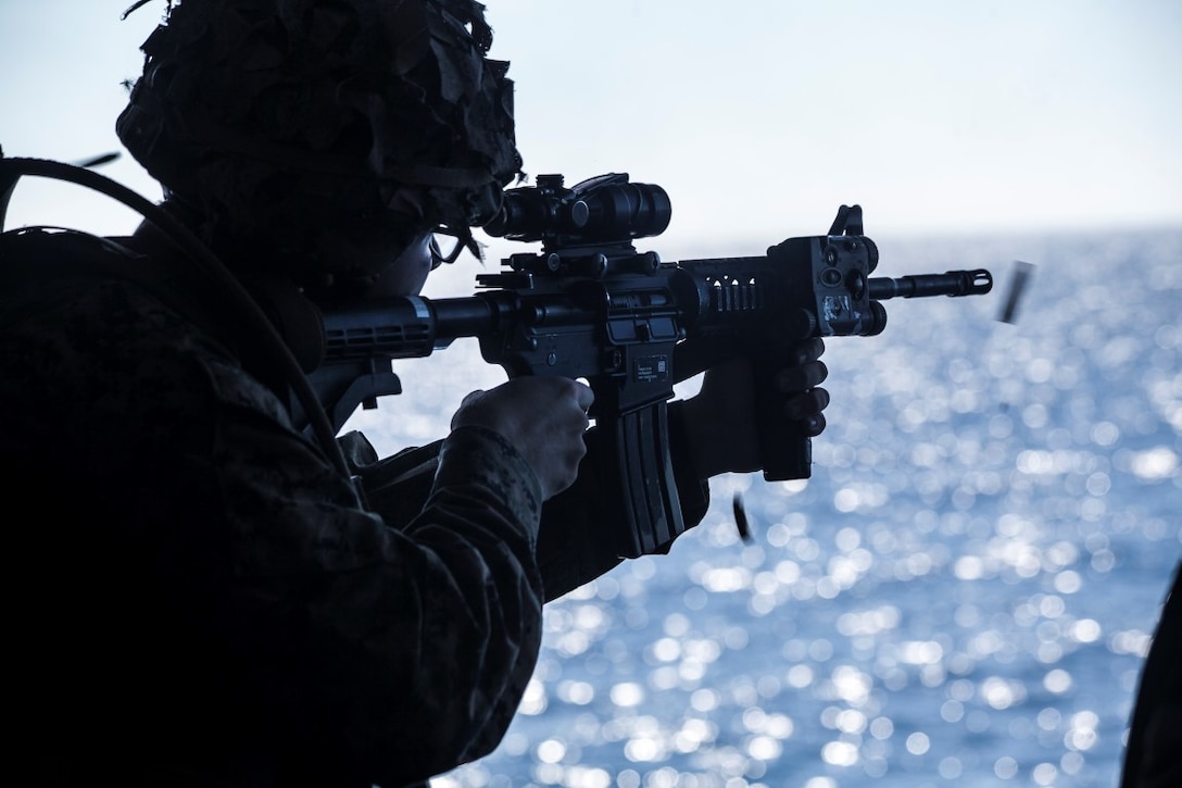 SOUTH CHINA SEA (Nov. 14, 2015) A U.S. Marine with Lima Company, Battalion Landing Team 3rd Battalion, 1st Marine Regiment, 15th Marine Expeditionary Unit, fires off rounds to check the functions of his M4 carbine during a quick reaction force rehearsal aboard the USS Essex (LHD 2). The 15th MEU is currently deployed in the Indo-Asia-Pacific region to promote regional stability and security in the U.S. 7th Fleet area of operations. (U.S. Marine Corps photo by Cpl. Elize McKelvey/Released)