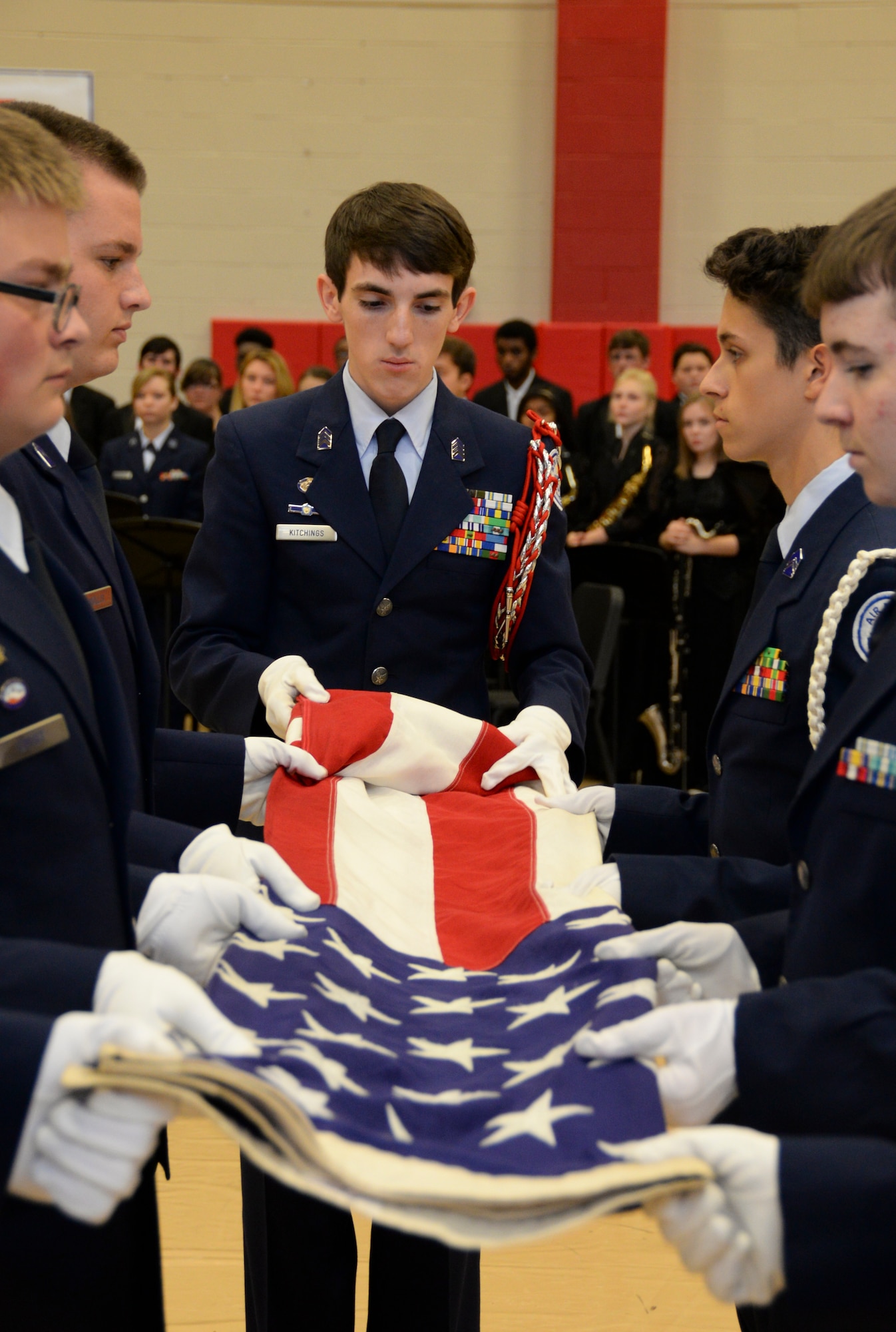 Junior ROTC students perform a flag folding detail during an annual Veterans Day Tattoo Ceremony at Parkway High School in Bossier City, La., Nov. 11, 2015. The students presented folded flags to Col. Trey Morriss, retired Col. Russ Mathers and retired Col. Warren Ward, 596th Bomb Squadron Airmen who participated in Operation Senior Surprise, as mementos of the event. Operation Senior Surprise was a clandestine mission that helped kick off Operation Desert Storm. (U.S. Air Force photo/Senior Airman Amanda Morris) 