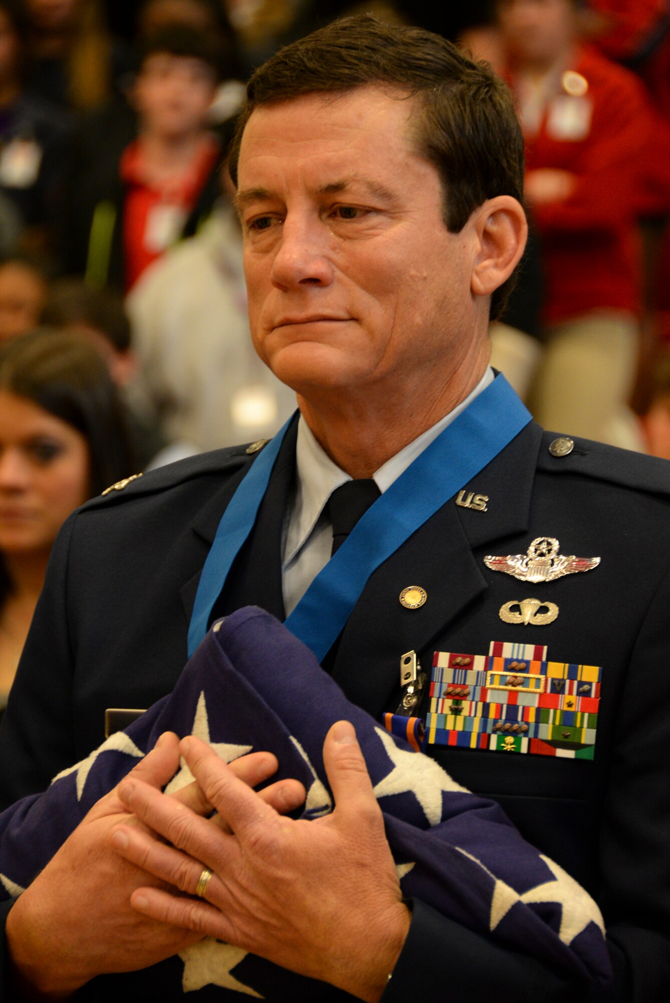 Retired Col. Warren Ward, 596th Bomb Squadron B-52G Stratofortress co-pilot during Operation Senior Surprise, holds an American flag presented by Junior ROTC students during an annual Veterans Day Tattoo Ceremony at Parkway High School in Bossier City, La., Nov. 11, 2015. Operation Senior Surprise was a clandestine mission that helped kick off Operation Desert Storm. JROTC students presented folded flags to Ward, Col. Trey Morriss and retired Col. Russ Mathers, 596th BS Airmen that participated in Operation Senior Surprise, as mementos of the event. (U.S. Air Force photo/Senior Airman Amanda Morris)
