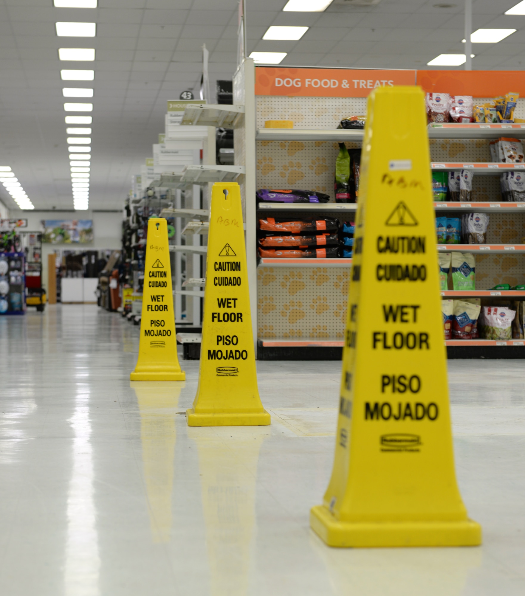 Caution signs alert customers to potentially slippery floors in the Exchange at Barksdale Air Force Base, La., Oct. 19, 2015. During the remodel the Exchange is remaining open and construction is ongoing as customers and employees continue to work and shop. (U.S. Air Force photo/Airman 1st Class Curt Beach)