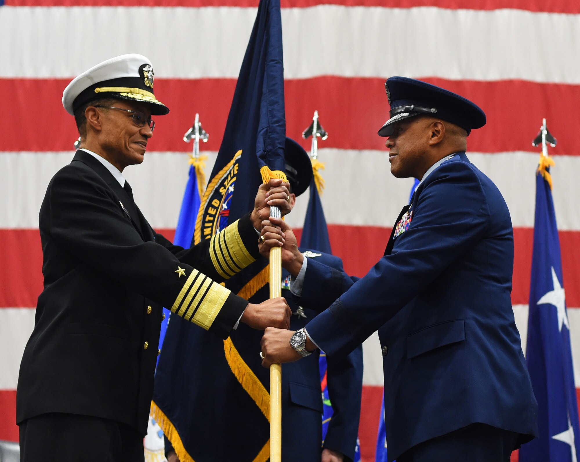 Adm. Cecil D. Haney, U.S. Strategic Command commander, presents the Task Force 214 guidon to Maj. Gen. Anthony J. Cotton as Cotton takes command of the task force during a ceremony on F.E. Warren Air Force Base, Wyo., Nov. 16, 2015. Cotton also took command of 20th Air Force from Gen. Robin Rand,
Air Force Global Strike Command commander, during the same ceremony. The task force provides the President of the United States with responsive and highly reliable strategic missile forces, and supports USSTRATCOM's strategic deterrence mission by operating and maintaining the Air Force's Intercontinental Ballistic Missile force. USSTRATCOM, one of nine DoD unified combatant commands, relies on various task forces for the execution of its global missions, which also include space operations; cyberspace operations; joint electronic warfare; global strike; missile defense; intelligence, surveillance and reconnaissance; combating weapons of mass destruction; and analysis and targeting. (U.S. Air Force photo by R.J. Oriez/Released)