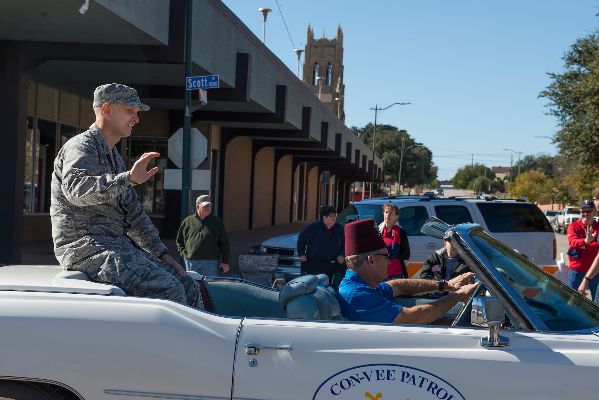 Col. Timothy Gillaspie, 82nd Training Wing vice commander, rides in a Cadillac in the Veterans Day parade as he passes through the streets of downtown Wichita Falls, Nov. 7, 2015. Gillaspie was invited to the review stand to watch the remainder of the parade. (U.S. Air Force photo/Senior Airman Kyle Gese)
