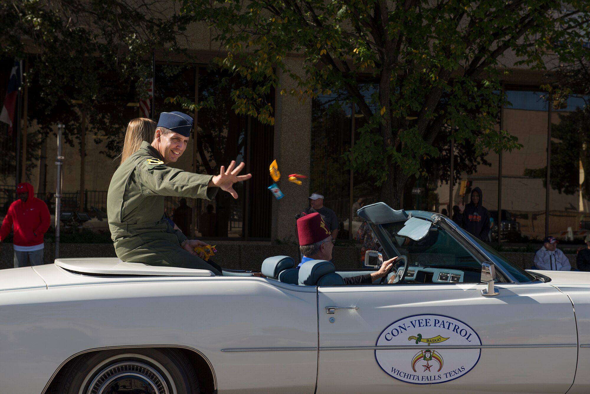 Col. Gregory Keeton, 80th Flying Training Wing commander, rides in a Cadillac in the Veterans Day parade as he passes through the streets of downtown Wichita Falls, Nov. 7, 2015. Keeton was invited to the review stand to watch the remainder of the parade. (U.S. Air Force photo/Senior Airman Kyle Gese)