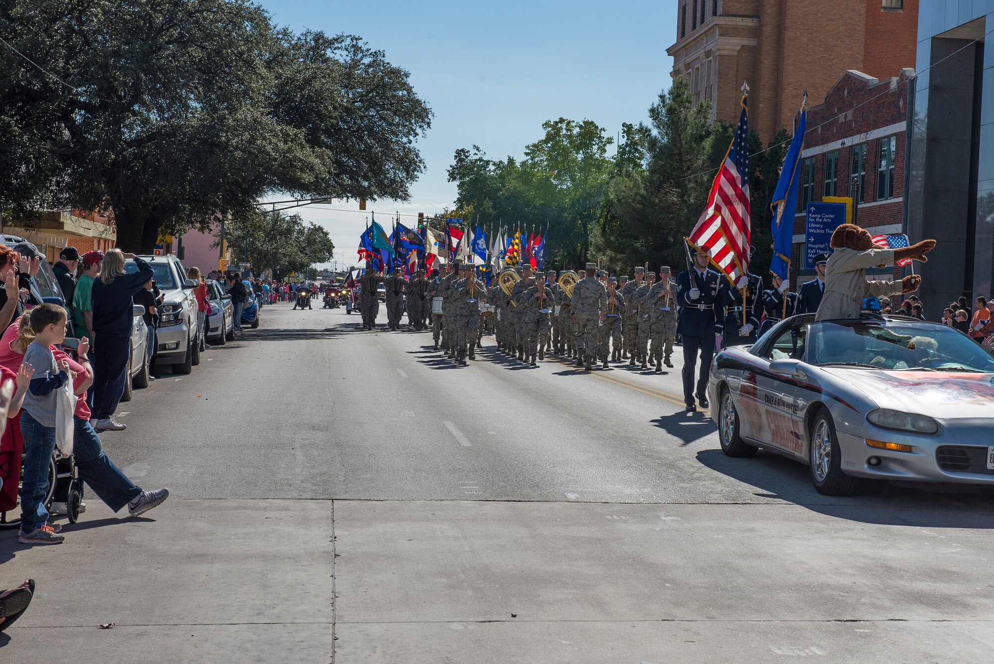 Airmen from Sheppard Air Force Base, Texas, march in the Veterans Day parade in downtown Wichita Falls, Nov. 7, 2015. Several flights of Airmen participated in the parade, marching with flags and playing patriotic music for the people of Wichita Falls. (U.S. Air Force photo/Senior Airman Kyle Gese)