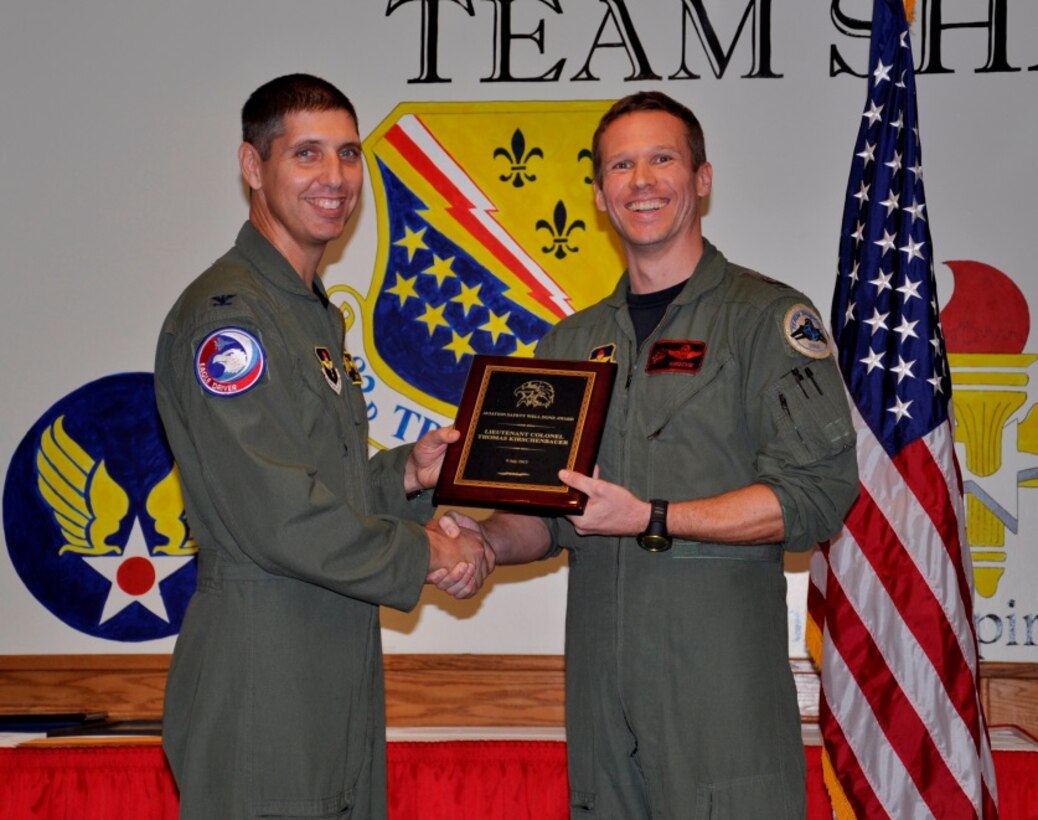 Col. Gregory Keeton (left), 80th Flying Training Wing commander, presents Lt. Col. Thomas Kirschenbauer, 88th Flying Training Squadron instructor pilot, the prestigious Aviation Safety Well Done Award during a warrior call Nov. 13, 2015 at Sheppard Air Force Base, Texas.  Kirschenbauer, a German Air Force instructor pilot with the Euro-NATO Joint Jet Pilot Training Program, used innovative communication methods and superb flying skills when an in-flight emergency bird strike threatened his T-38 Talon sortie. He is credited with saving two lives and the eight million dollar aircraft. (U.S. Air Force Photo/Debi Smith)